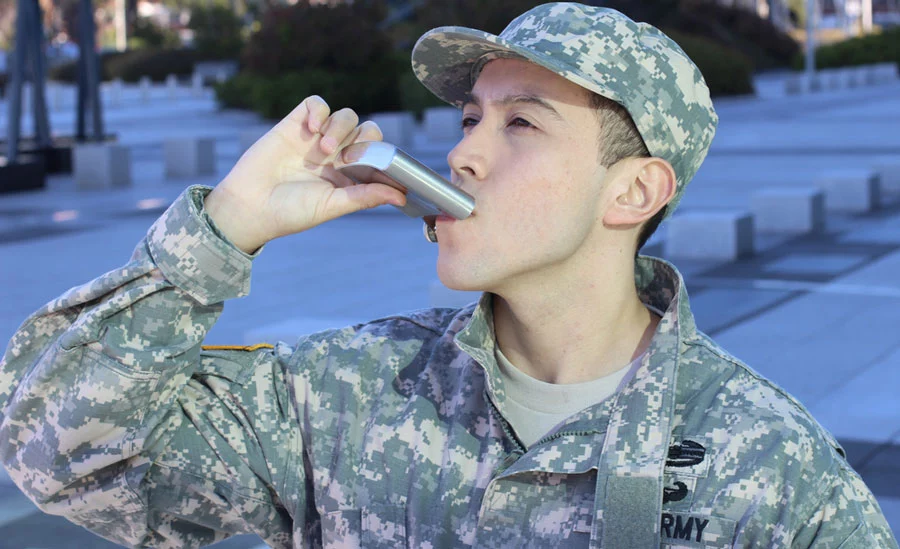 A soldier in the Army takes a swig from a flask not knowing TRICARE alcohol rehab services can be found at South Shores Recovery
