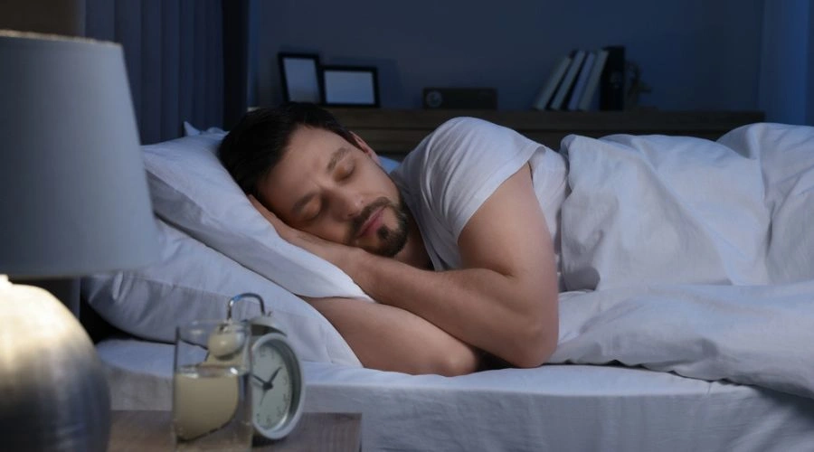 Man sleeping in bed Practicing self-care 