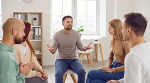 Men and women in group group therapy displaying what Is a day treatment program