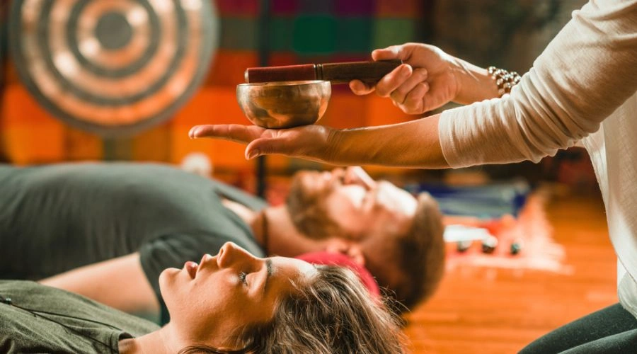 Image of man and woman meditating on the floor - Holistic Approach to Addiction Treatment at South Shore Detox