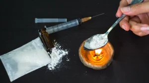 Image of a spoon with Ketamine powder being wamed - Can You Smoke Ketamine - South Shores Detox