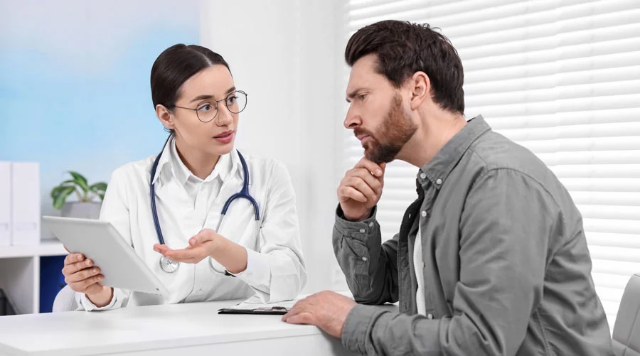 Image of a man sitting with a medical advisor, receiving medical supervision during his kratom detox