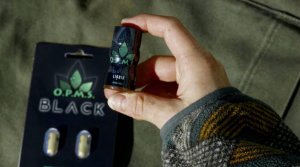 Image of a person holding an OPMS Kratom shot in her hand - What is OPMS Kratom and Is It Addictive - South Shores Detox