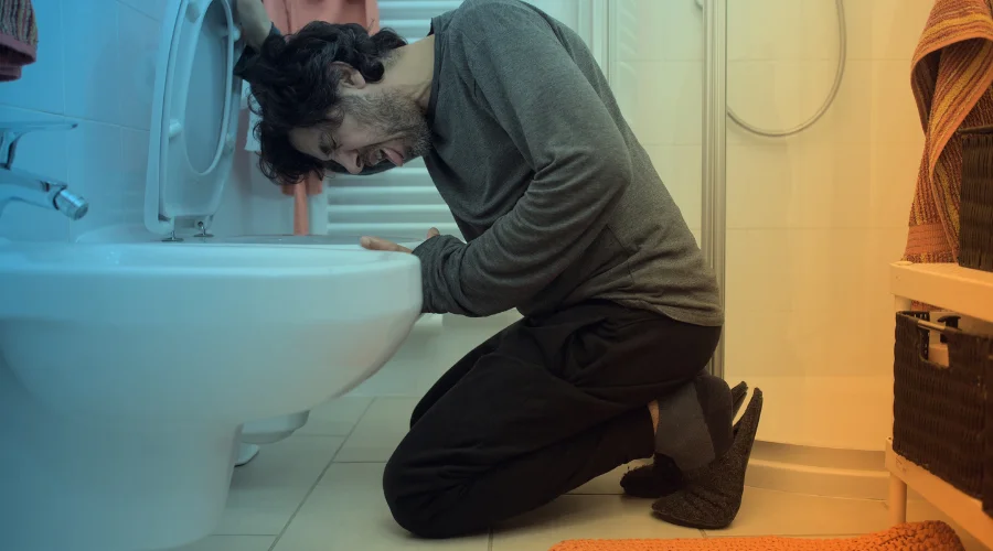 Image of a person experiencing physical discomfort from mitragynine pseudoindoxyl side effects